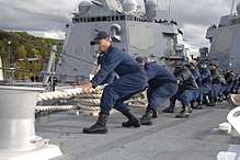 Navy Team Hauling In a mooring line